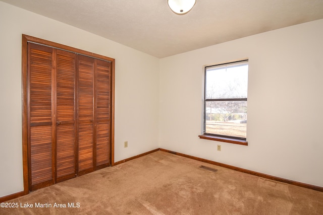 unfurnished bedroom with a closet and carpet