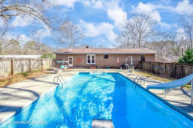 view of swimming pool featuring a patio and a water slide