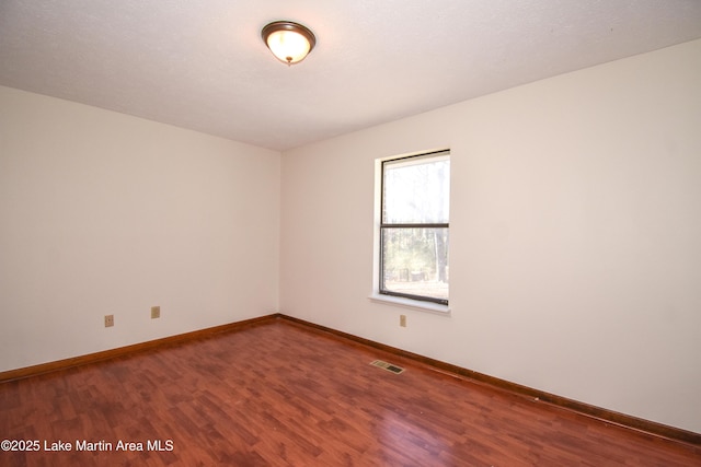 unfurnished room with hardwood / wood-style floors