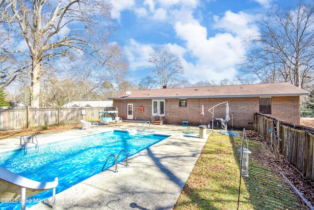 view of swimming pool featuring french doors and a patio