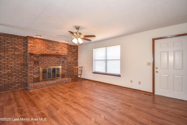 unfurnished living room with a fireplace, hardwood / wood-style floors, a textured ceiling, and ceiling fan