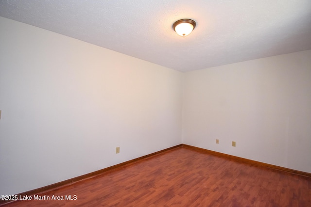 empty room with wood-type flooring