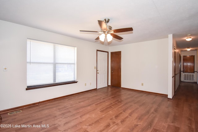 spare room with ceiling fan and dark hardwood / wood-style flooring