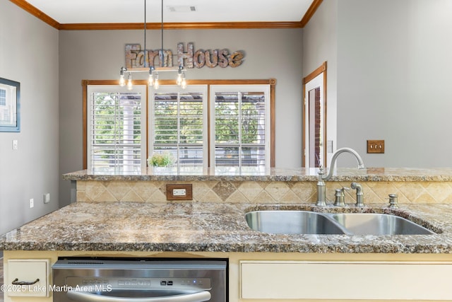 kitchen featuring crown molding, a healthy amount of sunlight, visible vents, and a sink