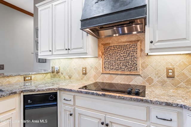 kitchen with black electric stovetop, custom range hood, backsplash, ornamental molding, and light stone countertops