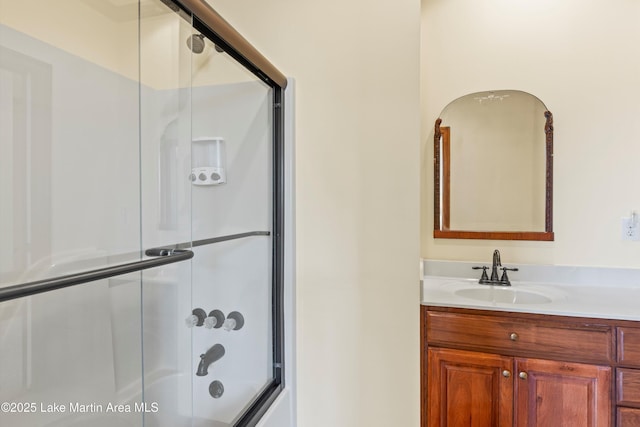 full bath featuring bath / shower combo with glass door and vanity