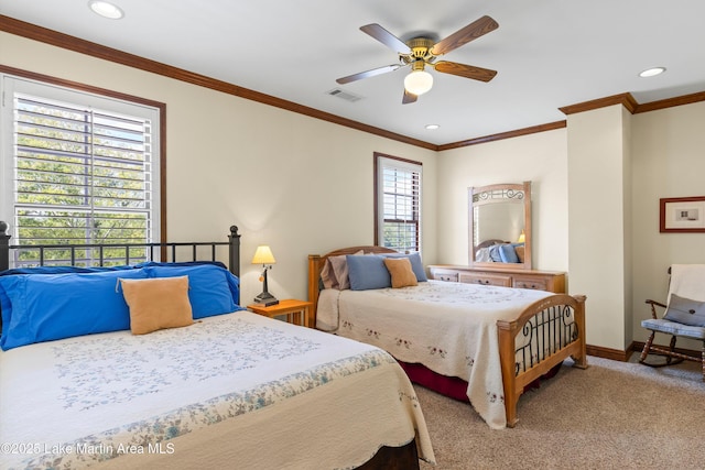 bedroom featuring visible vents, baseboards, a ceiling fan, carpet, and crown molding