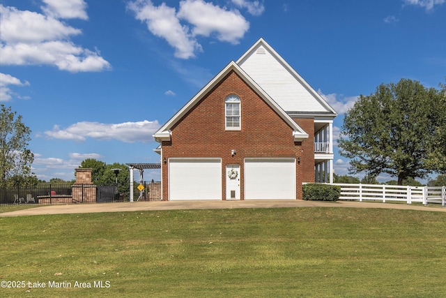 view of property exterior featuring brick siding, fence, driveway, and a lawn