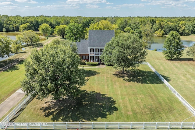 drone / aerial view featuring a water view and a wooded view