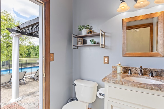 half bath featuring vanity and toilet