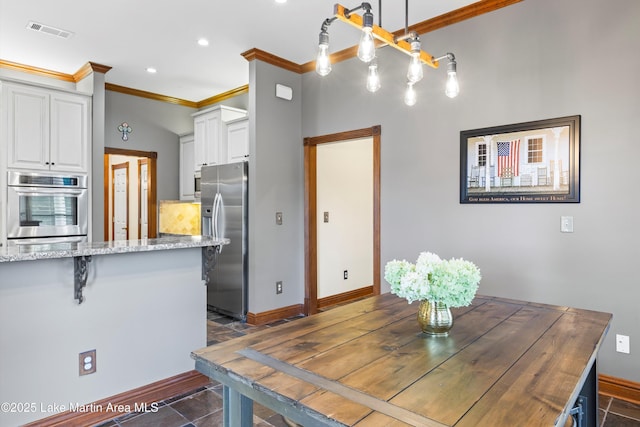 dining room featuring baseboards, visible vents, ornamental molding, and recessed lighting