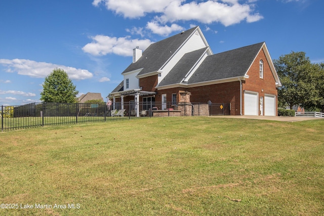 view of front of property with brick siding, a chimney, concrete driveway, fence, and a front lawn