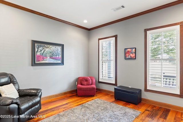 sitting room featuring a healthy amount of sunlight, visible vents, and wood finished floors