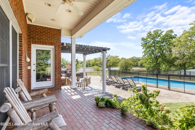 view of patio / terrace featuring ceiling fan, fence, a fenced in pool, and a pergola