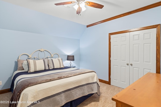 bedroom with ceiling fan, carpet flooring, baseboards, vaulted ceiling, and a closet