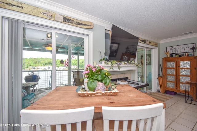 128 River Ridge Rd Unit B3, Alexander City, AL 35010 - tiled dining space with ornamental molding, a textured ceiling, and ceiling fan