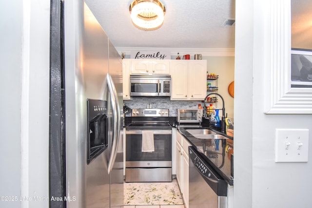 128 River Ridge Rd Unit B3, Alexander City, AL 35010 - kitchen featuring stainless steel appliances, dark countertops, backsplash, a sink, and ornamental molding