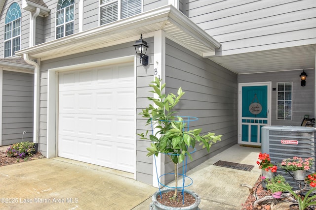 128 River Ridge Rd Unit B3, Alexander City, AL 35010 - doorway to property with a garage, central air condition unit, and concrete driveway