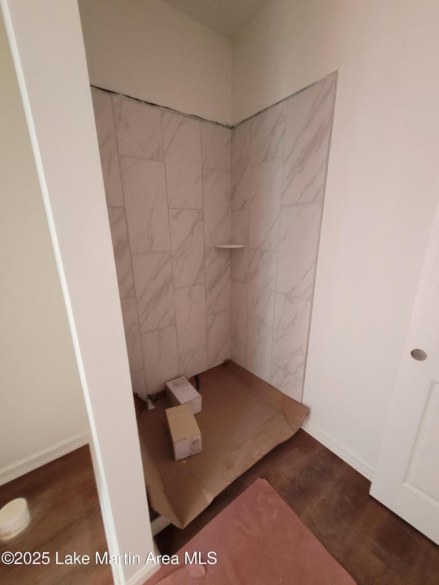 198 Mccain Rd, Eclectic, AL 36024 - full bath with tiled shower and wood finished floors