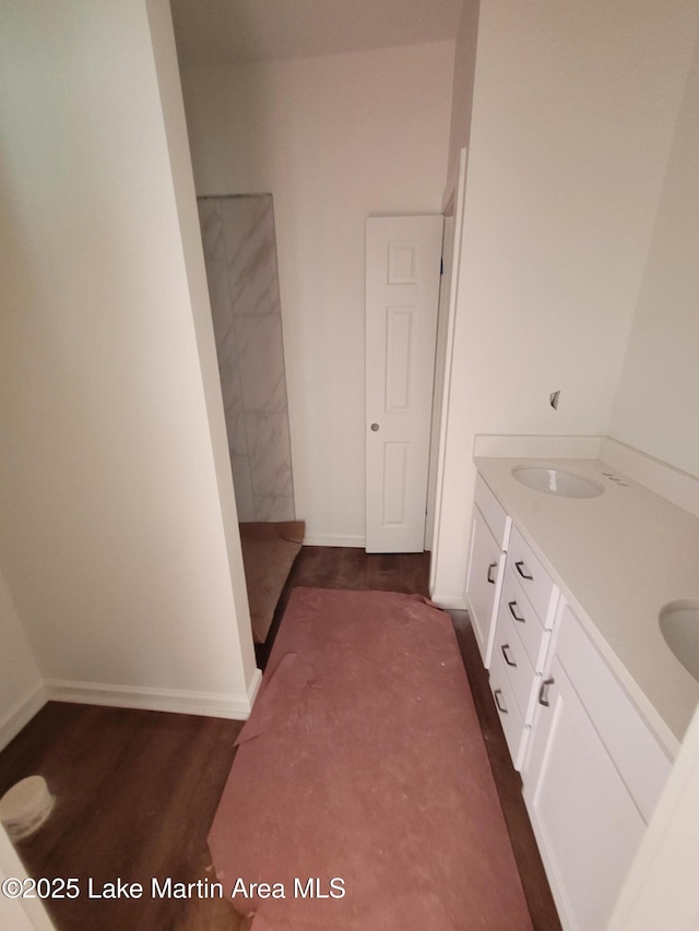 198 Mccain Rd, Eclectic, AL 36024 - full bath with a walk in shower, double vanity, and wood finished floors