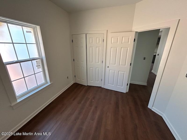 198 Mccain Rd, Eclectic, AL 36024 - unfurnished bedroom with dark wood finished floors and a closet