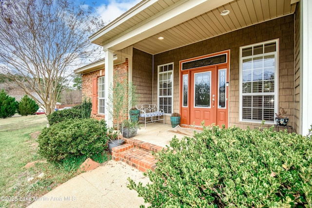 view of exterior entry with covered porch