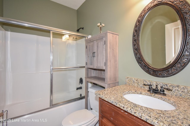 full bath with vanity, toilet, and combined bath / shower with glass door