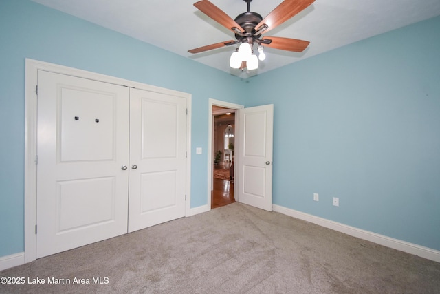 unfurnished bedroom with a closet, baseboards, and carpet