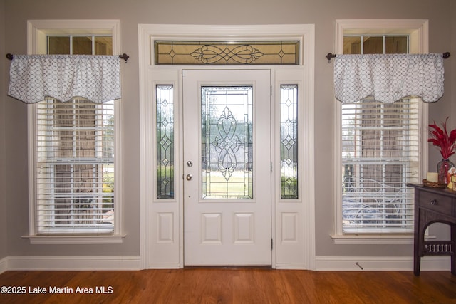 foyer with baseboards and wood finished floors