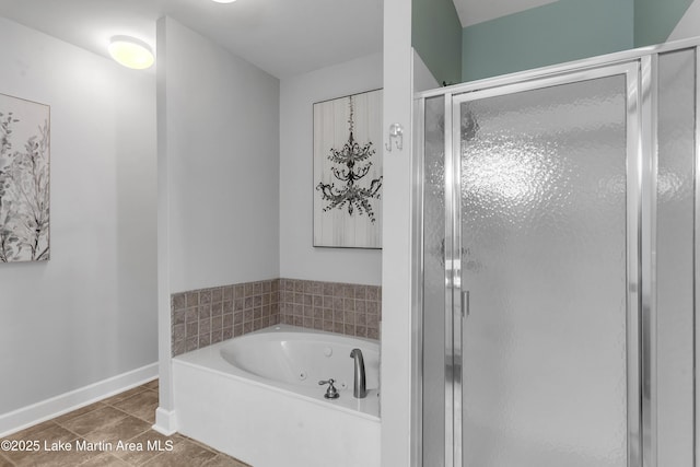 230 Crowne Pointe Rd Unit 104, Dadeville, AL 36853 - full bathroom with a jetted tub, a stall shower, tile patterned flooring, and baseboards
