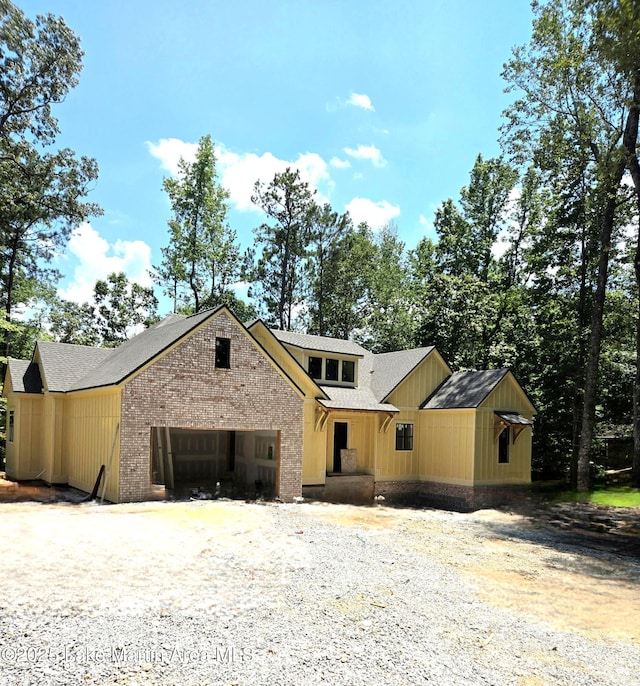 154 Hickory Way, Dadeville, AL 36853 - view of front of house with driveway, a garage, roof with shingles, and brick siding