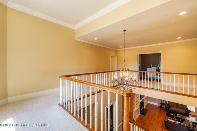 hallway featuring carpet flooring, a notable chandelier, and ornamental molding