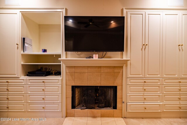 tiled living room featuring a tiled fireplace