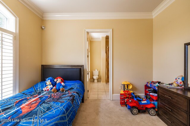 bedroom featuring crown molding, light carpet, and connected bathroom