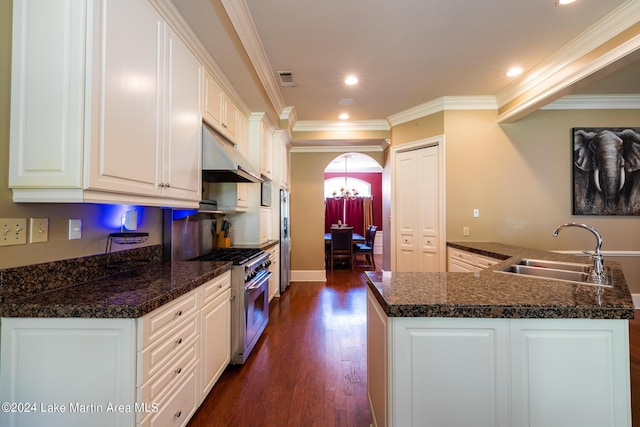 kitchen with sink, dark wood-type flooring, appliances with stainless steel finishes, white cabinets, and ornamental molding