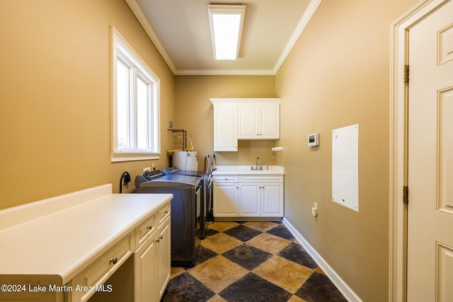 washroom featuring separate washer and dryer, crown molding, sink, and cabinets