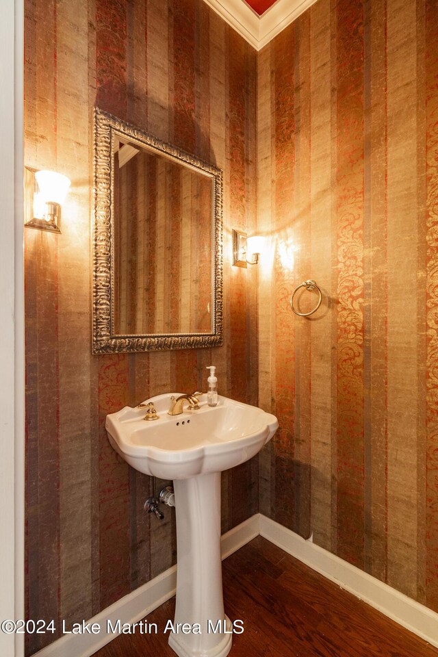 bathroom featuring hardwood / wood-style flooring and ornamental molding