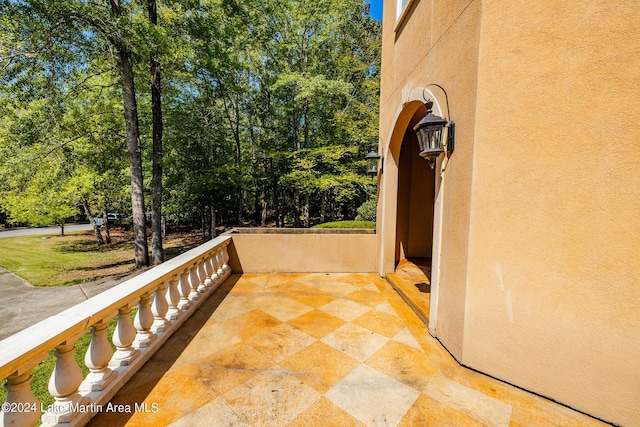 view of patio featuring a balcony