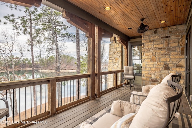 unfurnished sunroom featuring a water view and wooden ceiling