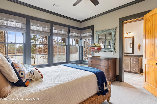 bedroom featuring multiple windows, ornamental molding, light carpet, and ensuite bathroom