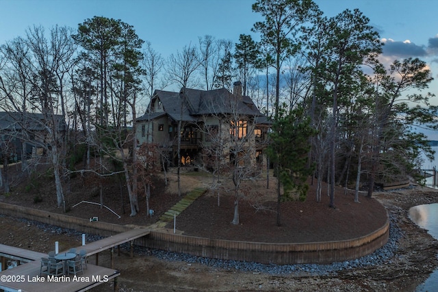 view of back house at dusk