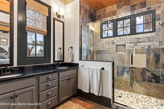 bathroom with plenty of natural light, an enclosed shower, tile walls, and vanity