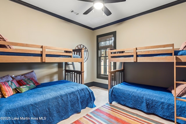 carpeted bedroom with crown molding and ceiling fan