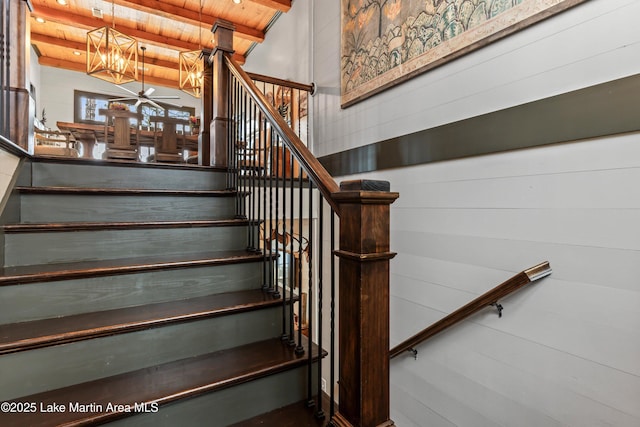 stairway with beamed ceiling and wooden ceiling