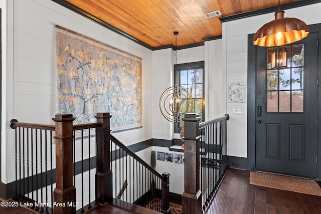 foyer with crown molding, dark hardwood / wood-style flooring, and wooden ceiling