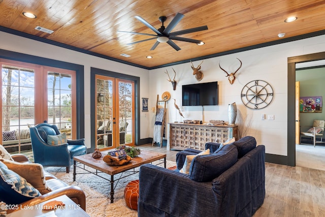 living room with ornamental molding, light hardwood / wood-style floors, wood ceiling, and french doors