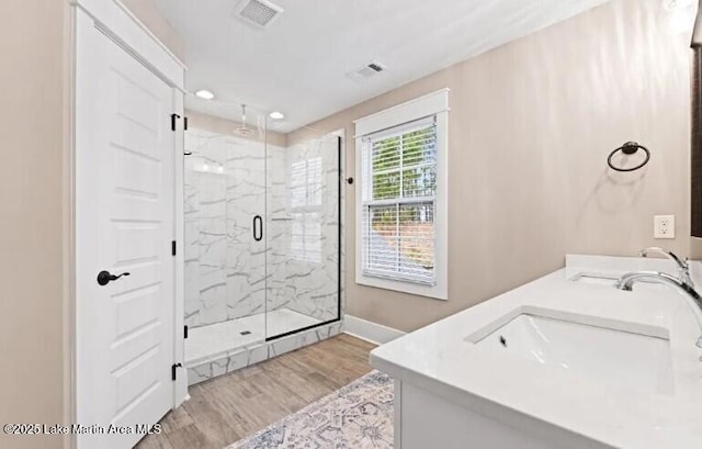 bathroom featuring vanity, an enclosed shower, and hardwood / wood-style floors