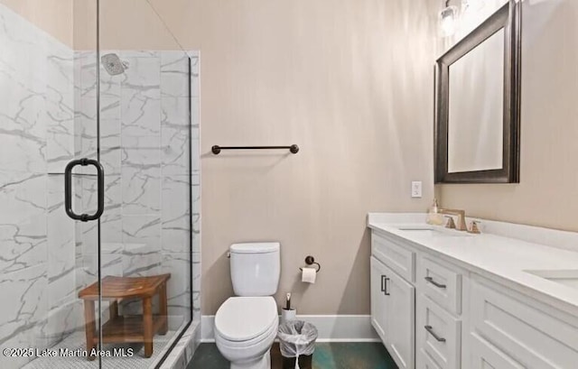 bathroom featuring vanity, toilet, and a shower with door