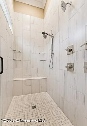 bathroom with a shower with door