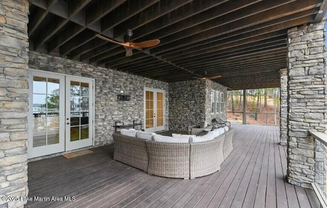 wooden terrace featuring an outdoor living space and french doors